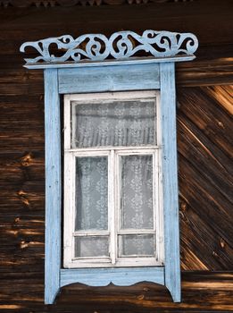 Old rustic wall with a window. Fragment, close-up. Rural life.