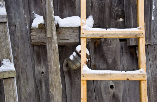 Old wooden barn wall. Wooden stairs and an old lamp. Rural life