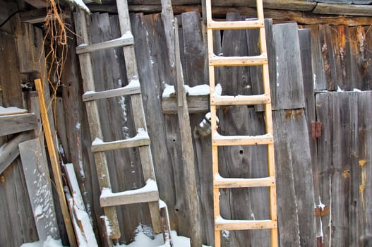 Old wooden barn wall. Wooden stairs and an old lamp. Rural life