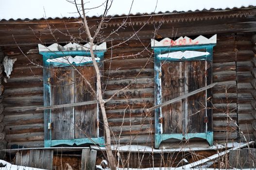 Old rustic wall with a window. Fragment, close-up. Rural life.