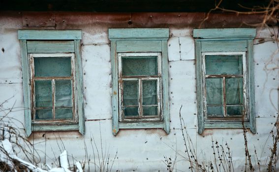 Old rustic wall with a window. Fragment, close-up. Rural life.