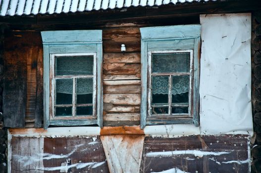 Old rustic wall with a window. Fragment, close-up. Rural life.