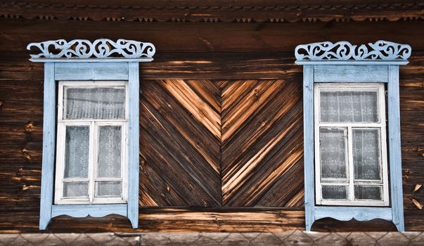 Old rustic wall with a window. Fragment, close-up. Rural life.