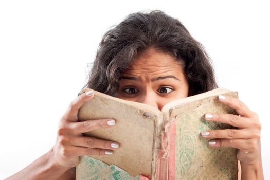 Young indian surprised girl reading old book