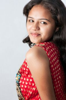 Shy smile of beautiful Indian girl, isolated on white background