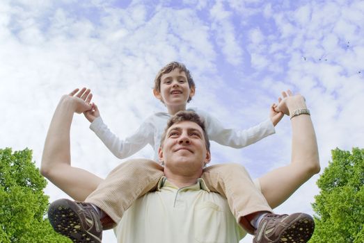 Father and son against the cloudy sky