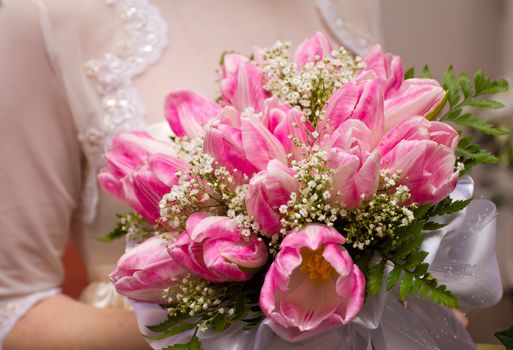 wedding bouquet in hands of bride