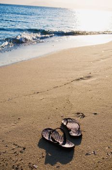 Pair of Flip Flops on sandy Beach