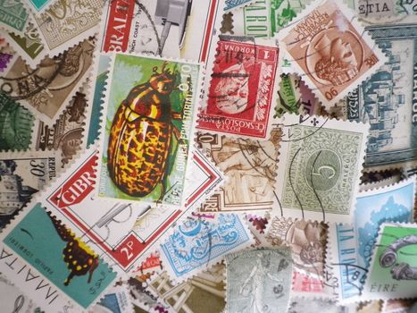 an assortment of old franked postage stamps