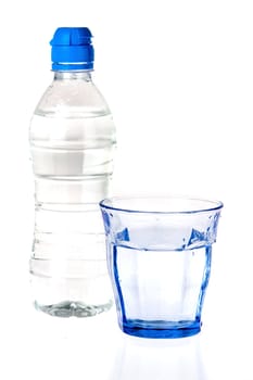 a blue glass and a bottle of water on a white background