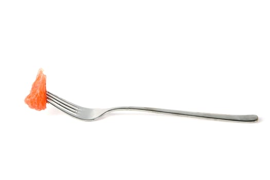 a fork with a piece of grapefruit on a white background