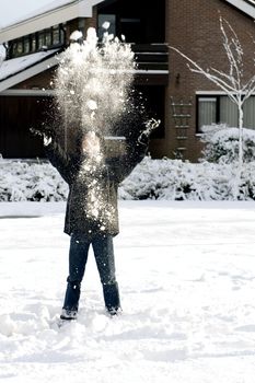 a young boy in the snow having fun