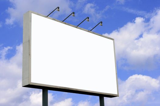 Blank Billboard  with lamps and blank screen for commercial use in a sky blue background.
