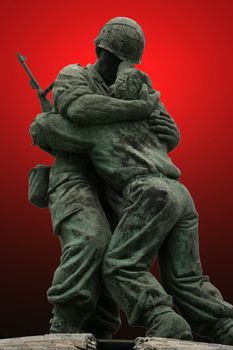 An unknown soldier statue in the Korean Memorial in Seoul Korea with a bright red gradient background