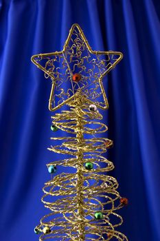 Metallic christmas tree on blue background