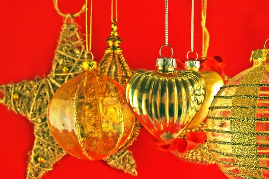 Many decorated christmas balls and a star on red background