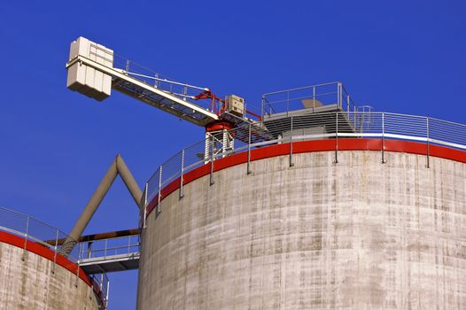 Crane ans silos under construction against a blue sky