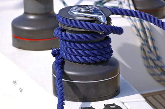 Winch with blue rope on a sailing boat
