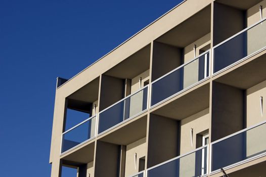 Front of building with terraces against a blue sky