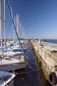 Boats moored to wharf in a harbour