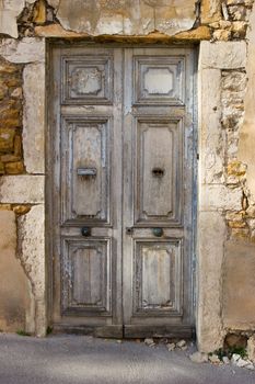 Old weathered wooden door with sunbeam on it
