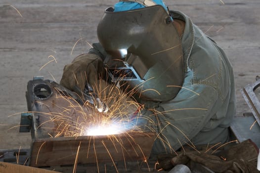 a welder working at shipyard during day shift