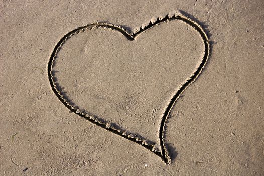 Drawed heart in the sand on a beach