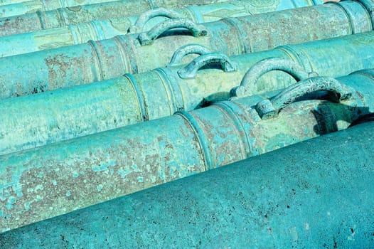 Ancient French howitzer. Cast iron cannons in the row