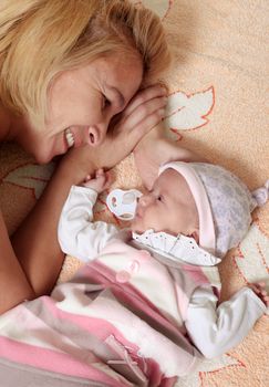 Mother with her newborn baby in home