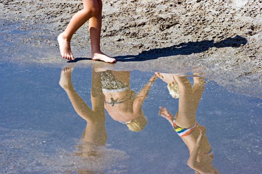 Children playing on the beach in summer sunshine