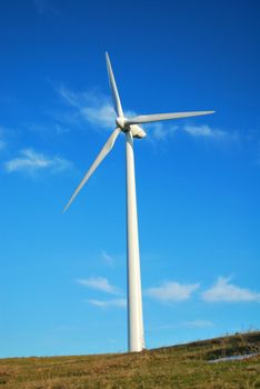 Windmill in Romania gathers energy from the summer breeze.