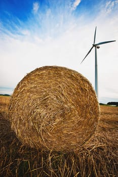 Big Haybale in front of a Wind Turbine