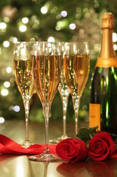 Glasses of Champagne with red roses ready to celebrate