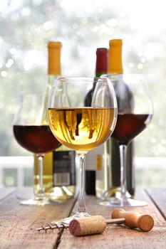 Glasses of white and red wine on wooden table