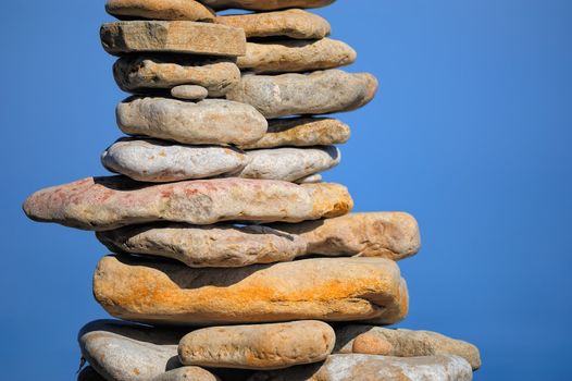 Stout pile of pebbles on the sea shore