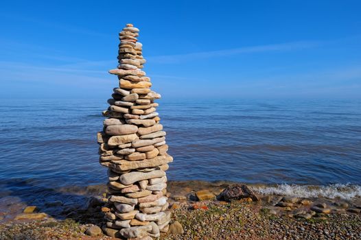 Stout pile of pebbles on the sea shore