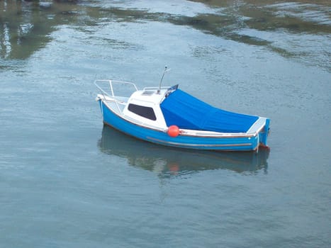 Photo of an isolated small blue boat