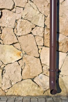 background texture of a brick wall with a pipe running through it