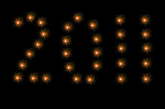 Many small orange illuminated fibre optic lamps arranged over white to spell the number 2011