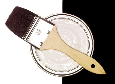 Paint can with brush on black and white background