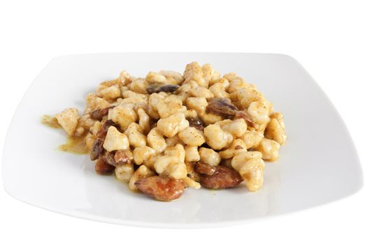 chicken with almonds and curry sauce isolated on white