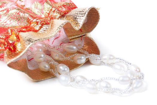 Closeup view of necklace with pearls and gift bag