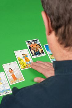 Overhead take of a concentrated tarot reader