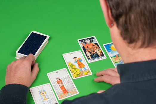 Overhead take of a concentrated tarot reader