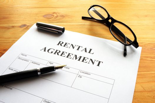 rental agreement form on desktop in business office showing real estate concept