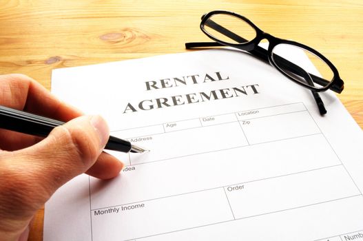 rental agreement form on desktop in business office showing real estate concept
