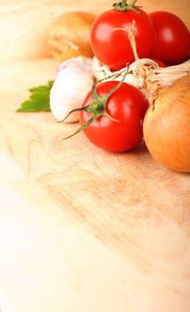 tomatoes garlic and other vegetables in kitchen showing healthy food concept