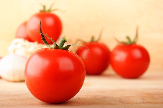 tomatoes and garlic in kitchen on wood with copyspace