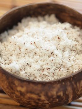 close up of bowl of grated coconut