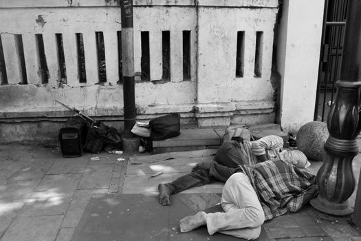 two man asleep on the roadside.